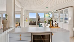 A modern kitchen with a large island, built-in wine cooler, and a view of the sea. - "Alimpij" - 5m from the sea by Interhome (Børkop)