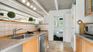 A modern kitchen with granite countertops, stainless steel appliances, and wooden cabinets.