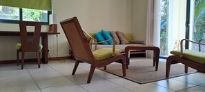 Relax in this inviting living area with a sofa, armchairs, and a convenient table.