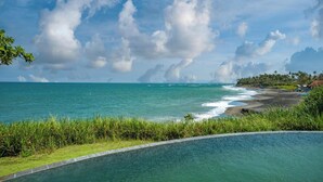 A pool with a view of the ocean and beach. - Bali Amori Vista (Cemagi)
