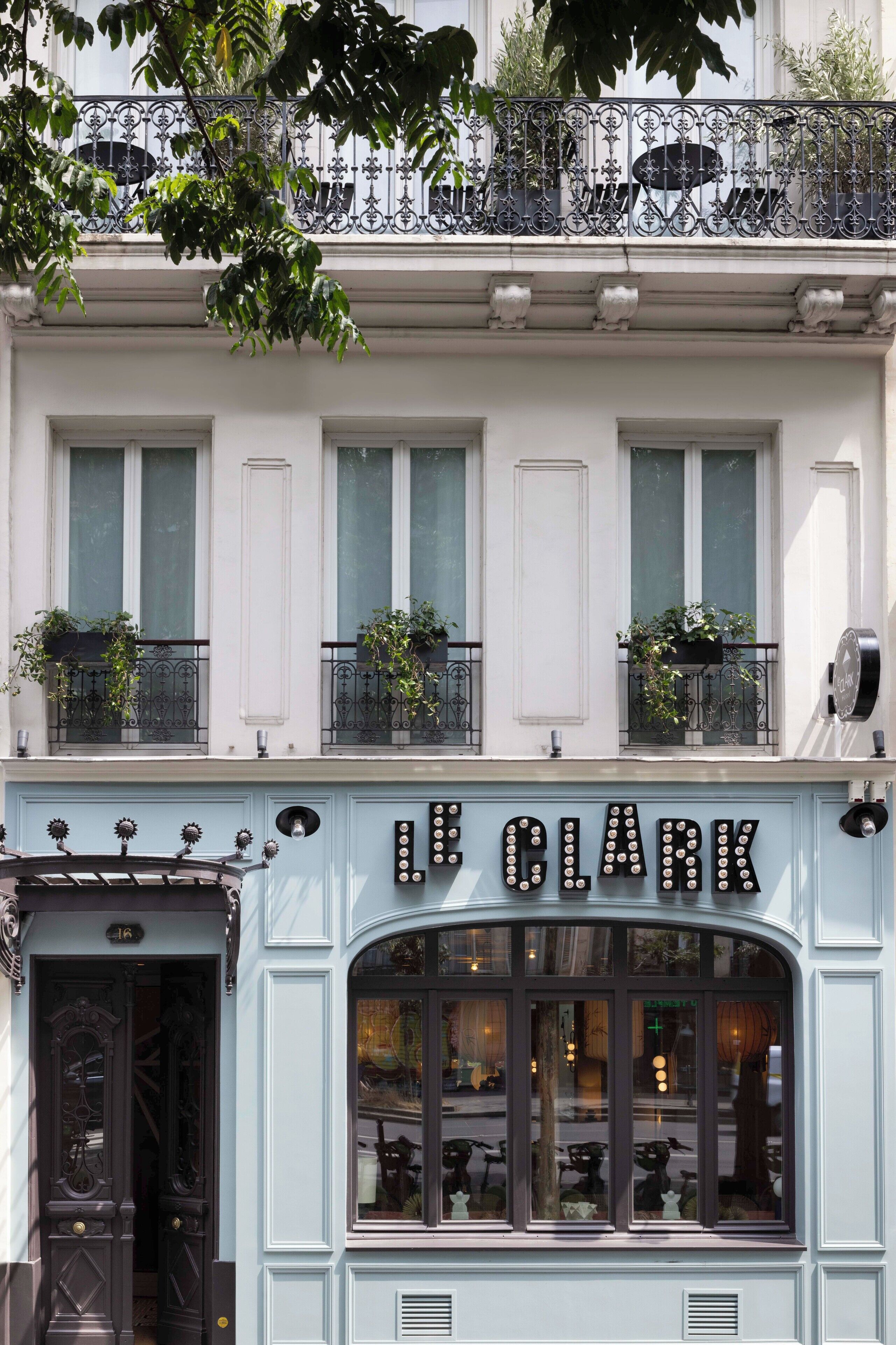A building with a sign reading "Le Clark" and a door with a number "16".
