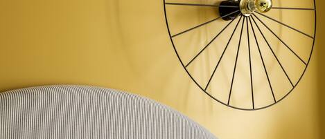 A wall-mounted clock with a circular design and a single hand.