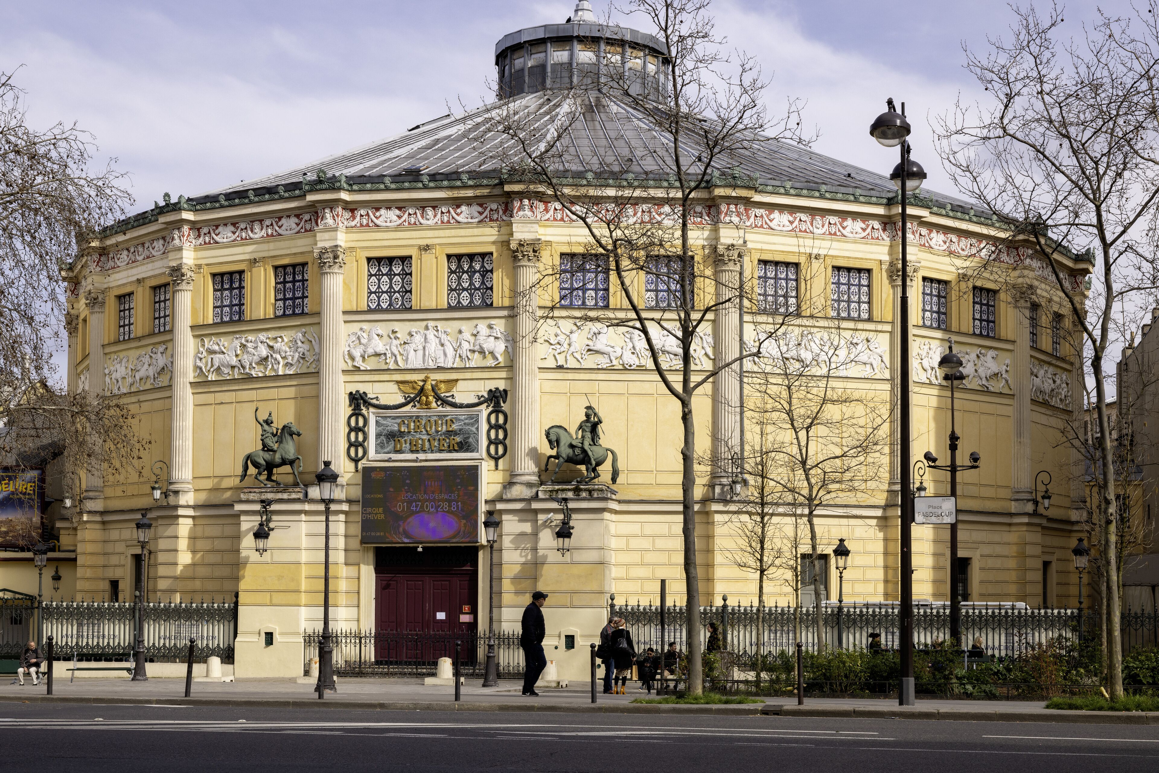 A historic building with ornate facades, large windows, and statues.