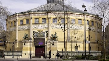 A historic building with ornate facades, large windows, and statues.