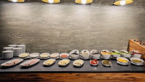 A buffet setup with various food items and plates. - Akhaltsikhe Inn (Akhaltsikhe)