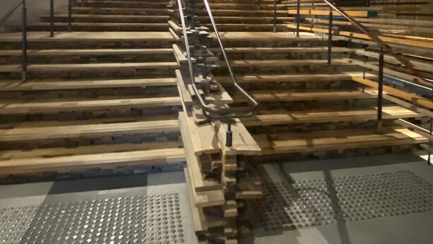 A staircase with metal railings leading up to a platform with wooden planks. - Sophisticated Lakeview Apt + Parking (Canberra)