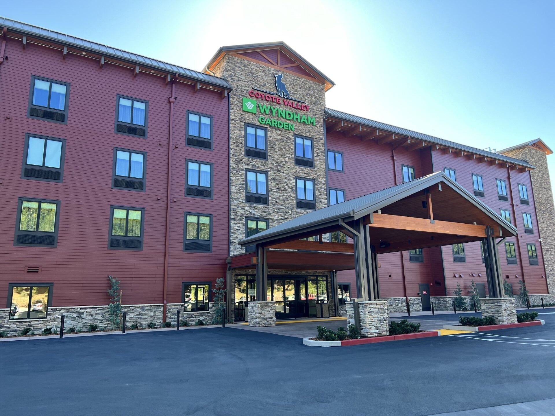 A multi-story hotel with a prominent entrance and a covered outdoor area.