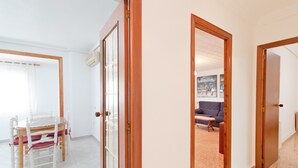 Une pièce comprenant une table à manger et des chaises, un canapé et un tableau accroché au mur.