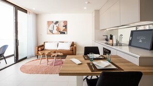 A modern living room with a sofa, coffee table, and dining area. - A134 - Panoramic View of the Lagoon (Sint Maarten)