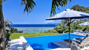 Piscine extérieure, parasols de plage, chaises longues