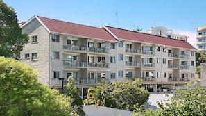 Stylish residential building with modern architecture and balconies.
