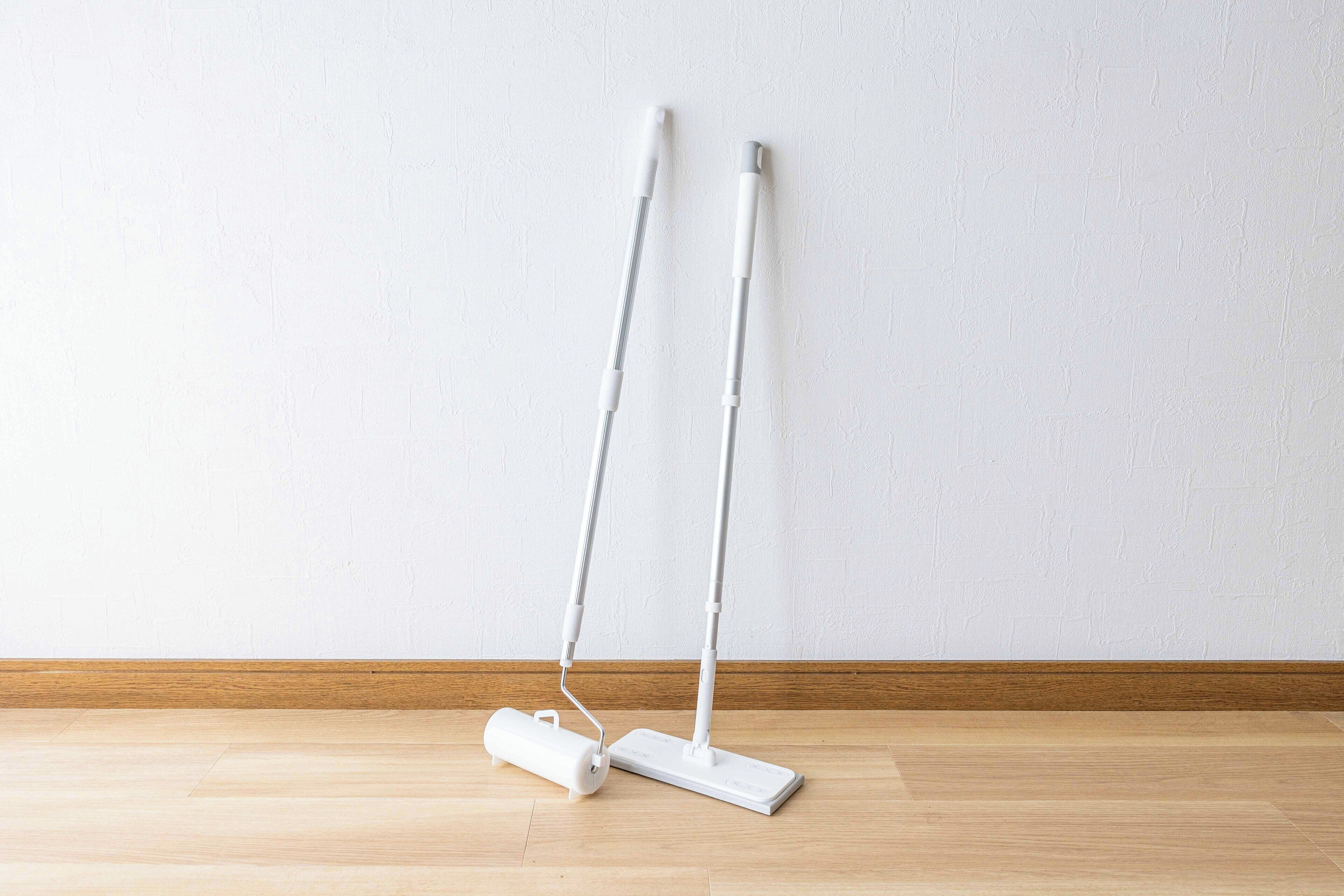 A room with a wooden floor and a white textured wall.