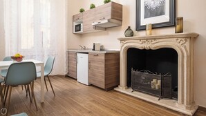 A modern kitchen with wooden cabinets, a built-in microwave, and a small refrigerator. - Italianway - Monza 39 (Milan)