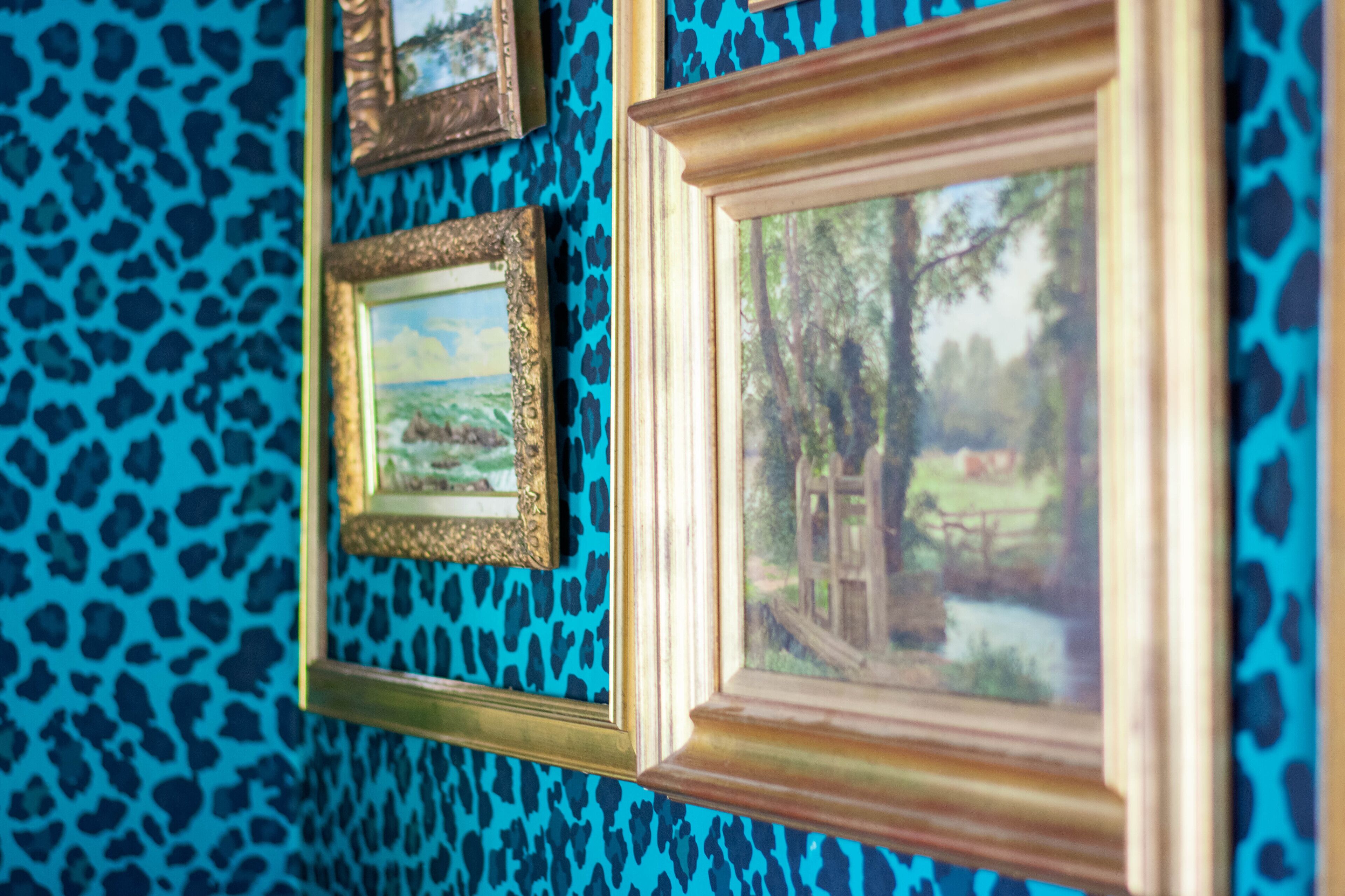 A wall with multiple framed pictures.