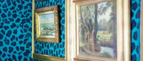 A wall with multiple framed pictures.