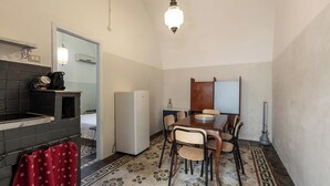 A compact kitchen with a refrigerator, a sink, and a dining table with chairs. - 3532 Borgo Vernicchia - PT by Barbarhouse (Parabita)