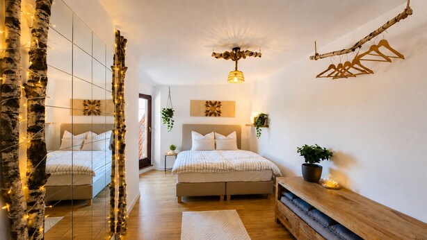 A bedroom with two beds, a mirror, a wooden dresser, and a hanging plant.