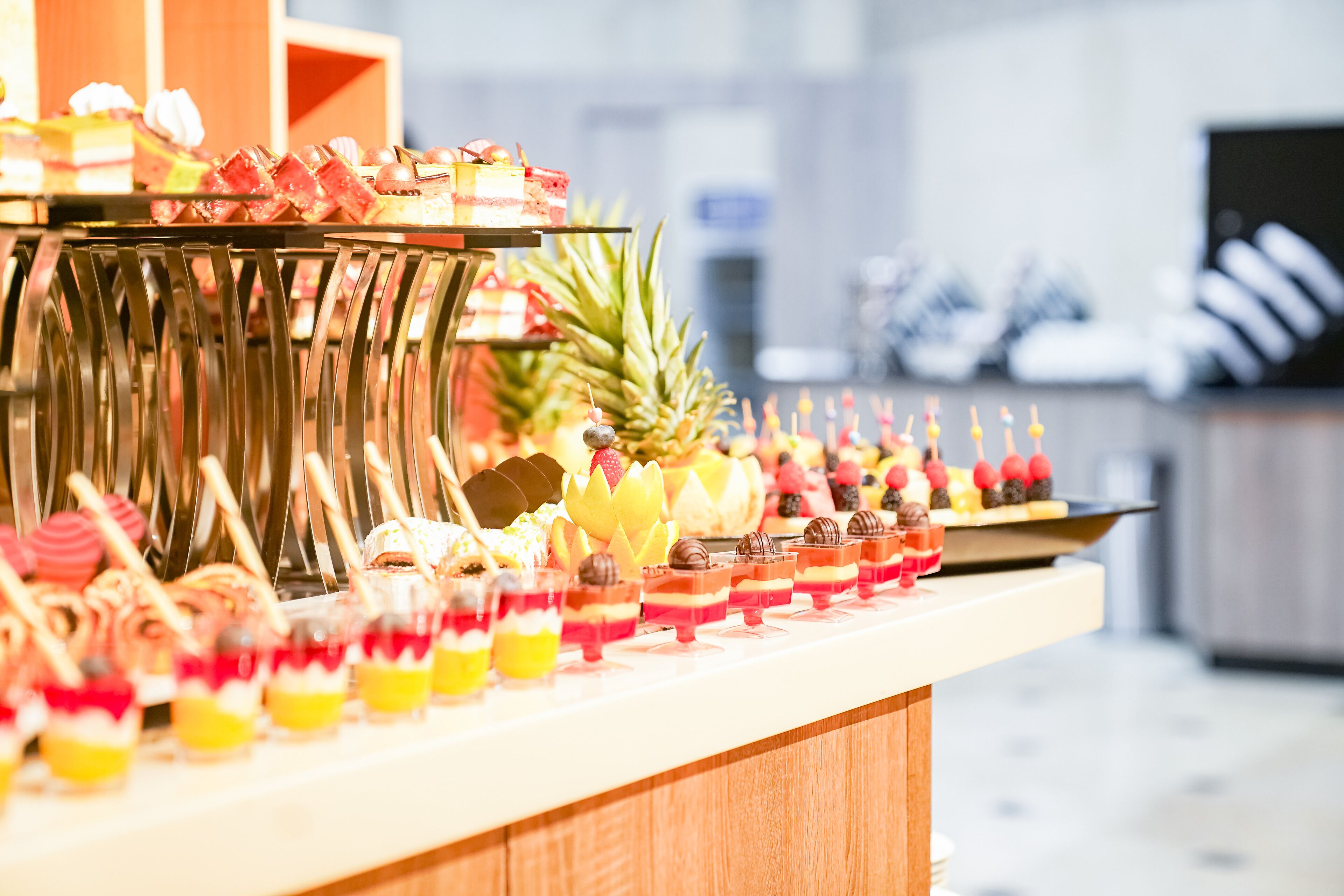 A buffet with various desserts and fruits.