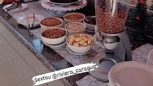 A buffet setup with various food items and a blender. - Pousada Riviera  (Caraguatatuba)