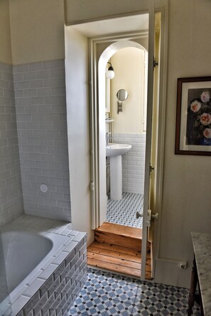 A bathroom with a bathtub, a sink, and a tiled floor. - House "henri Chardon" , A travel on the sea ! (Barfleur)
