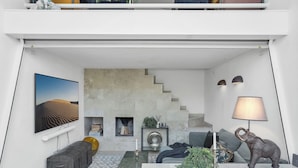 A modern living room with a sofa, coffee table, and decorative items. - One of Denmarks Most Famous Architect Spa Houses, First Beach Line (Blokhus)