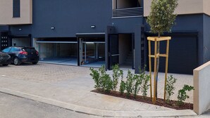 A modern building with a flat roof, multiple windows, and a garage entrance. - Hedera Estate, Hedera Studio 1 (Dubrovnik)