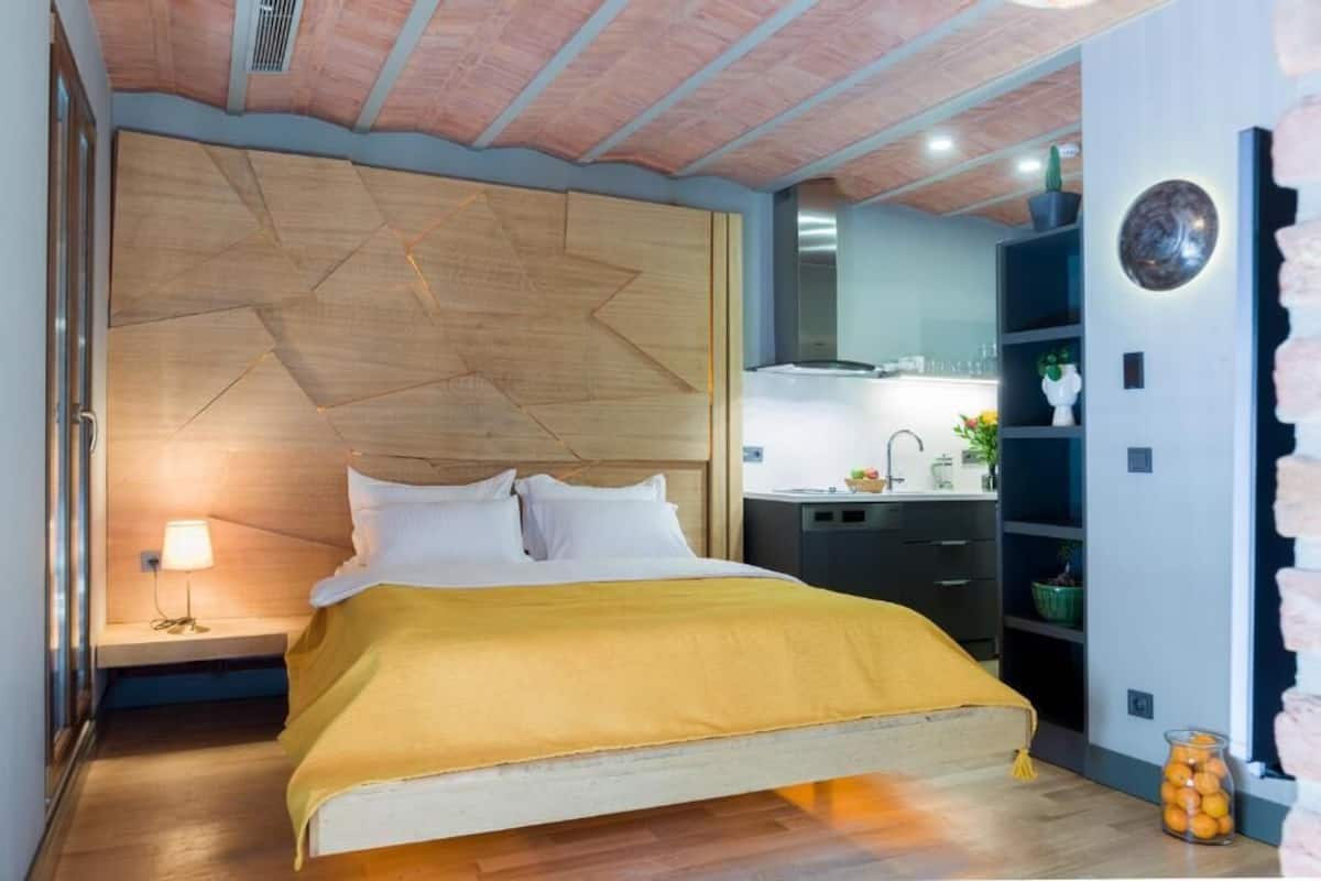 A bedroom with a bed, bedside table, and a nightstand.