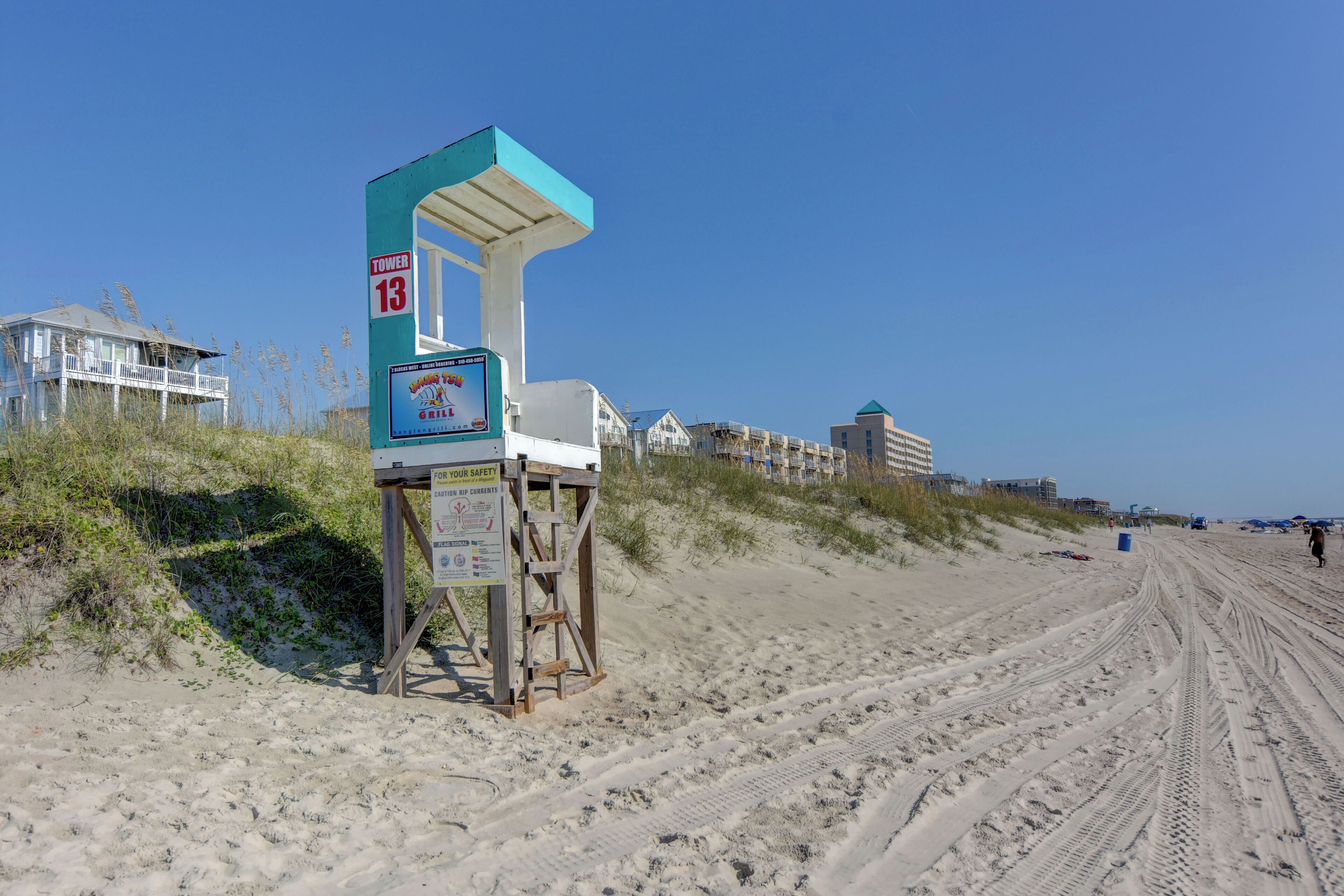 A lifeguard tower with a sign indicating it is Tower 13.
