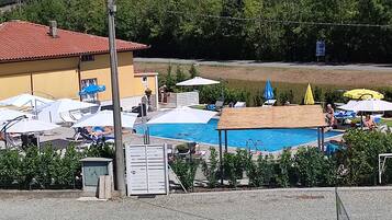 Seasonal outdoor pool, open 9:00 AM to 7:00 PM, pool umbrellas