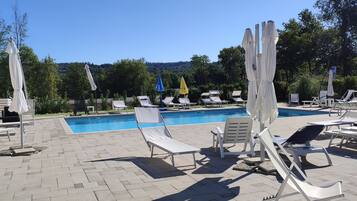 Alberca al aire libre por temporada y sombrillas en la alberca