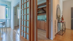 A modern kitchen with wooden cabinets, a stove, and a range hood.