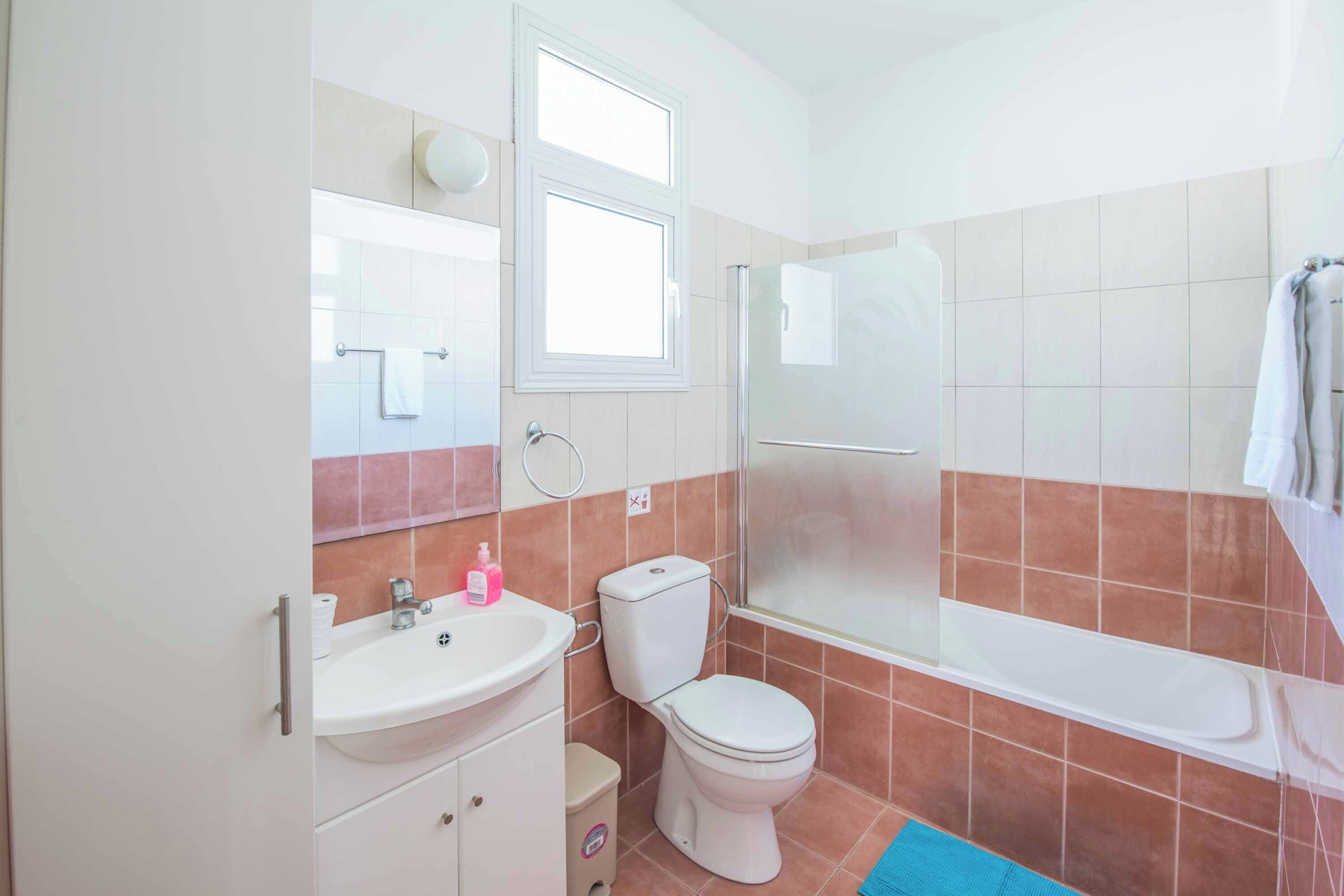 A bathroom with a sink, toilet, and bathtub.