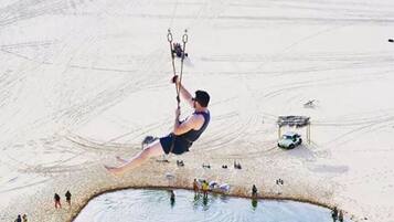Enjoy beach activities like trapeze and water sports in this lively public beach area.