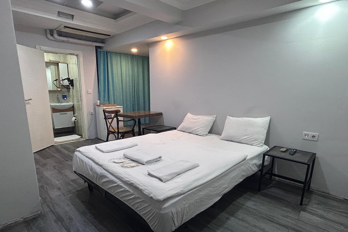 Economy Double Room | Minibar, desk, laptop workspace, blackout drapes