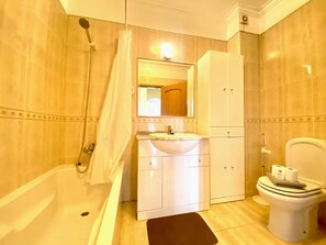 Bathtub, hair dryer, towels
