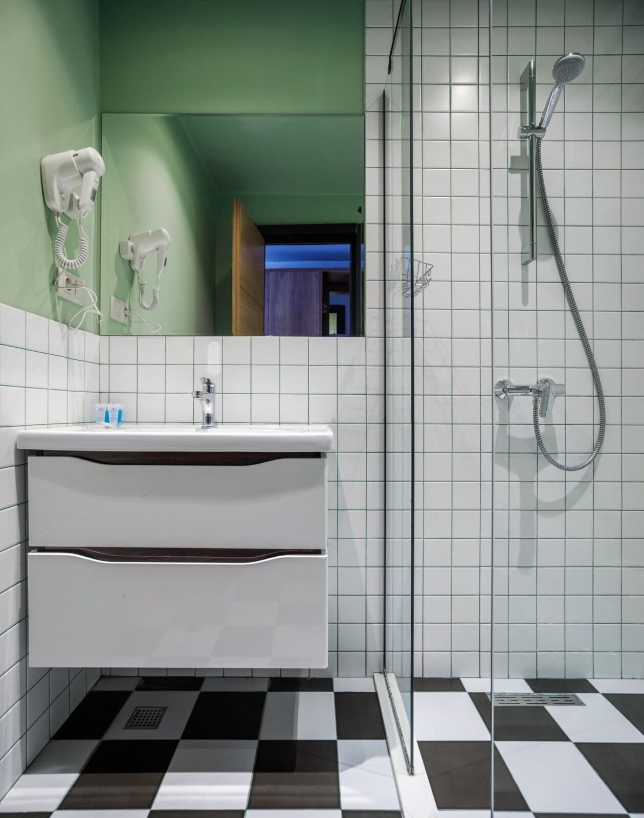 family studio suite | bathroom | shower, hair dryer, slippers, towels