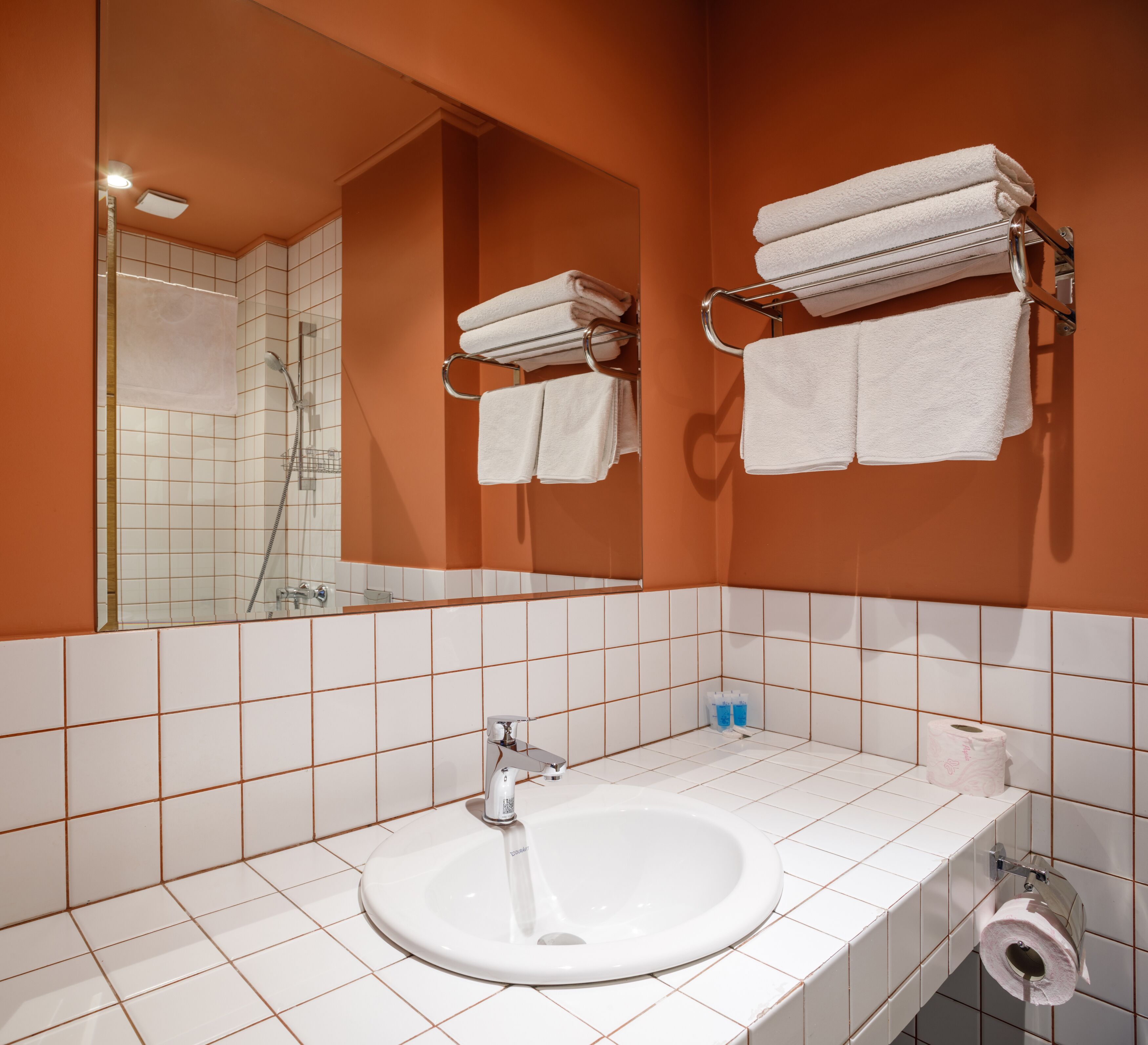 shower, hair dryer, slippers, towels