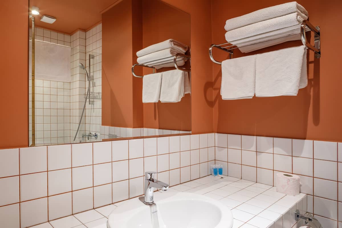 shower, hair dryer, slippers, towels