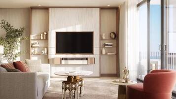 Una sala de estar moderna con un televisor de pantalla plana, un sofá, un sillón rojo y una mesa de centro.