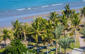 A beachside resort with palm trees, lounge chairs, and a view of the ocean. - Mandarin Oriental Muscat (Muscat)