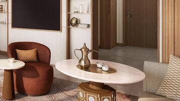 Una sala de estar moderna con una mesa redonda, un sillón rojo, una estantería y una puerta de madera.