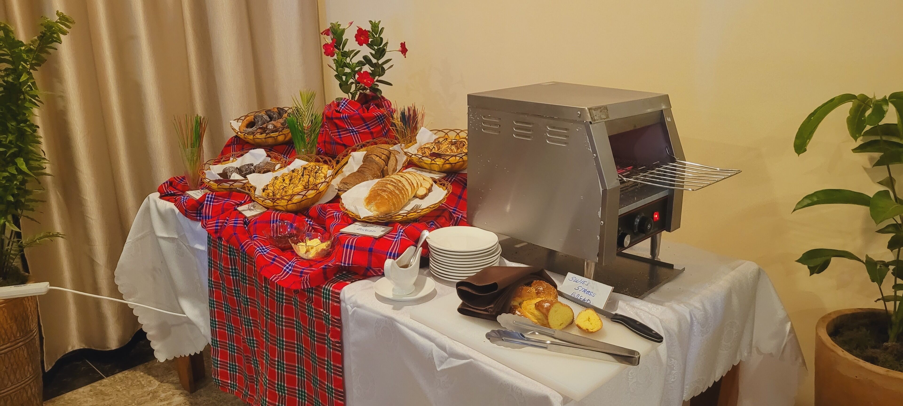 A buffet setup with various food items and a self-service oven.