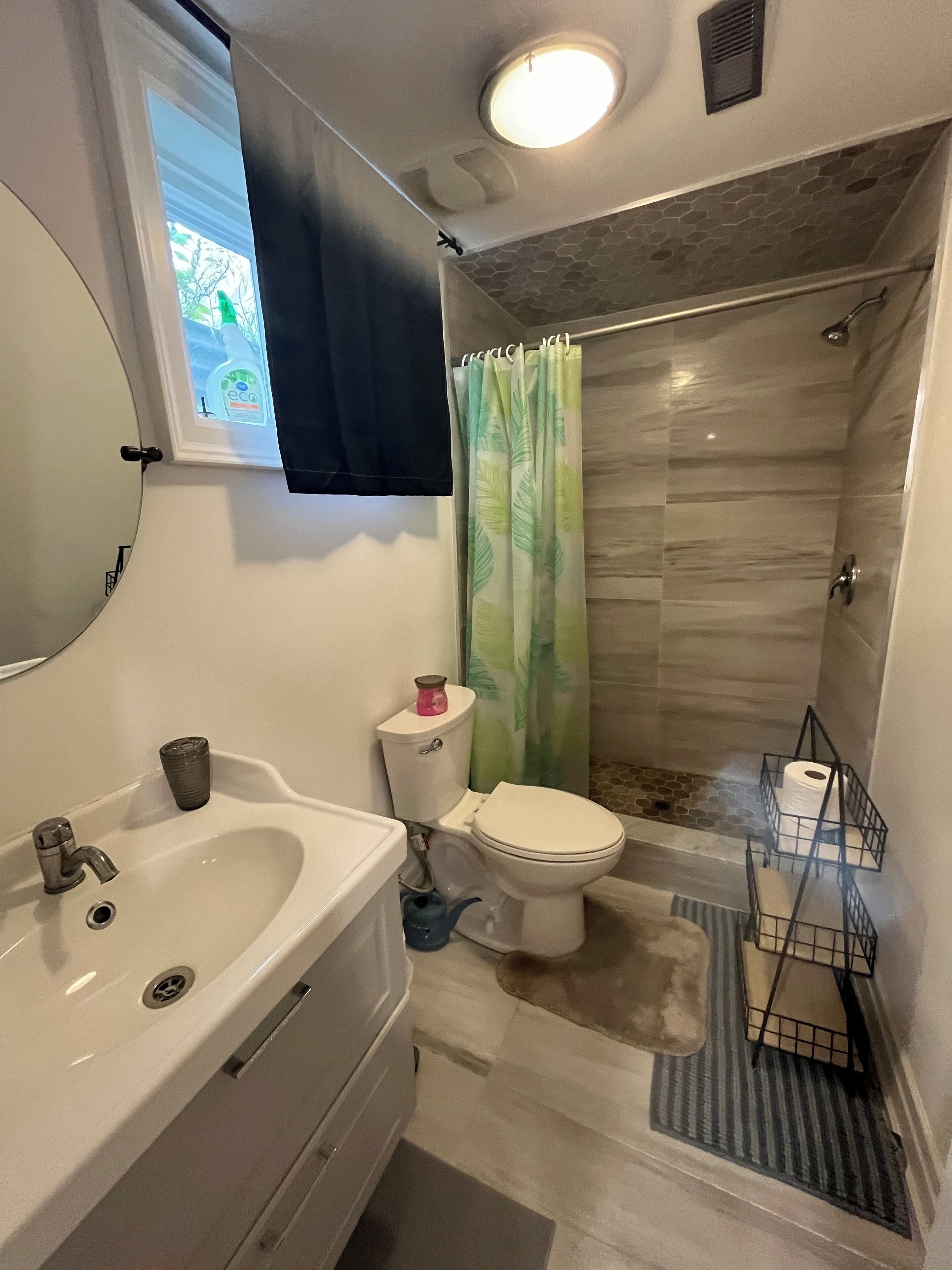 A bathroom with a sink, toilet, and shower.