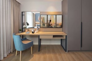 A modern room with a desk, chair, and a large window with a cityscape view. - Citadines Roces Quezon City (Quezon City)