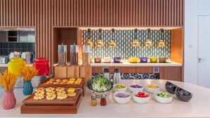 A buffet setup with various food items and condiments. - Holiday Inn Express Wenchang by IHG (Wenchang)
