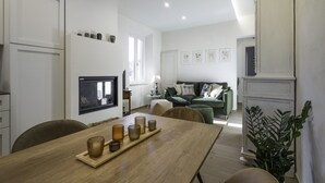 A modern kitchen with a wooden dining table, a built-in oven, and a large window. - Il Nespolo Charming Apartment Fonterutoli (Castellina in Chianti)