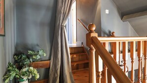 A staircase with wooden balusters and a handrail, leading to an upper floor. - The Waggon Shed (Nottingham)