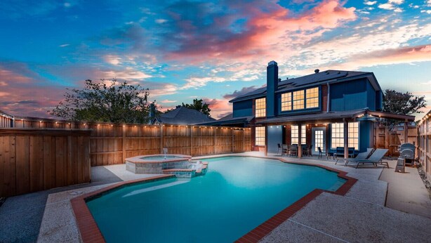A backyard with a swimming pool, hot tub, and outdoor seating area. - 6 Bedroom Home with Pool, Centrally Located (The Colony)