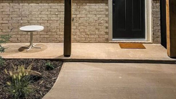 A house with a black door, a window with blinds, and a small table outside. - Upscale studio with skyline view (Abilene)