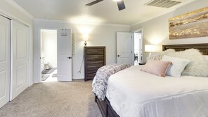 A bedroom with a bed, a ceiling fan, a dresser, and a painting on the wall. - < 1 Mi to OU Campus - Norman Vacation Rental (Norman)